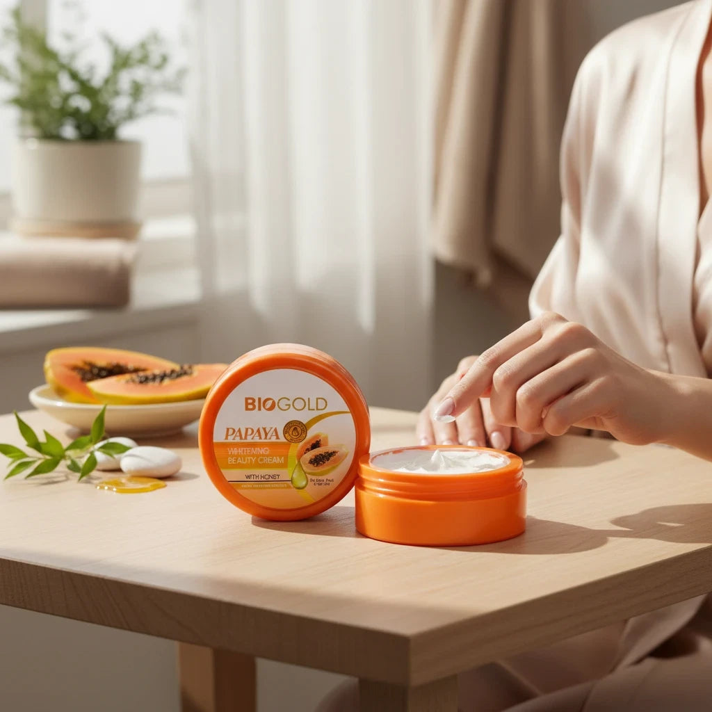 BIOCOS Cosmetics BIOGOLD papaya whitening cream with honey in an orange jar on a wooden table with fresh papaya slices